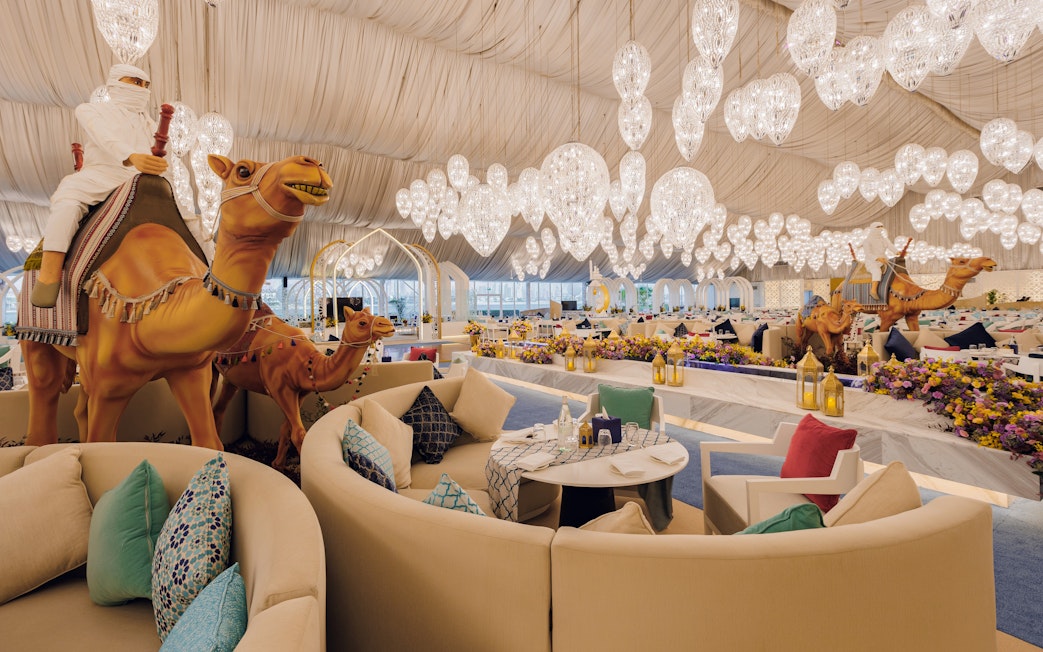 Interior of Asateer Tent at Atlantis, The Palm, Dubai, decorated for Ramadan with seating and chandeliers.