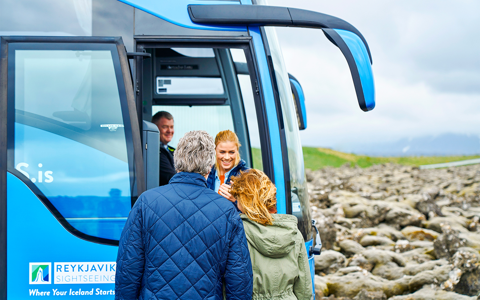 Tourists boarding Reykjavik Sightseeing transfer bus in Iceland.
