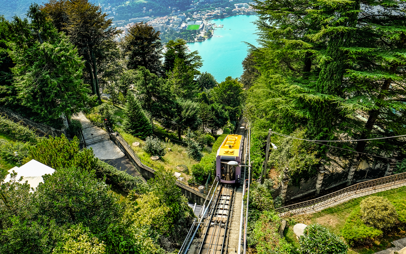 Lake Como with funicular railway ascending hillside in Italy.