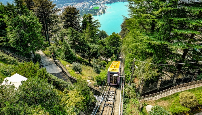 Lake Como with funicular railway ascending hillside in Italy.