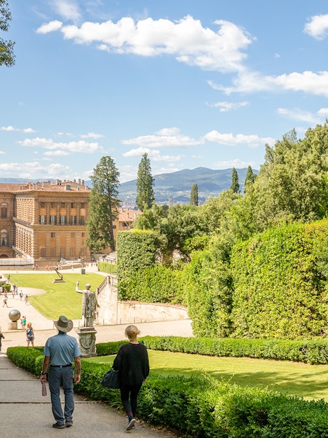 Visitors walking towards Pitti Palace through Boboli Garden in Florence, Italy.