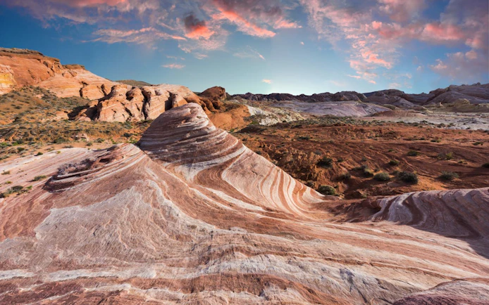 Valley of Fire's striped rock formations at sunset during a guided tour from Las Vegas.
