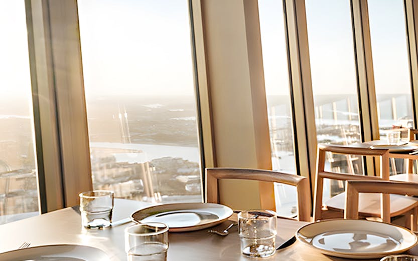 Dining table set at Skyfeast Sydney Skytower with panoramic city views.