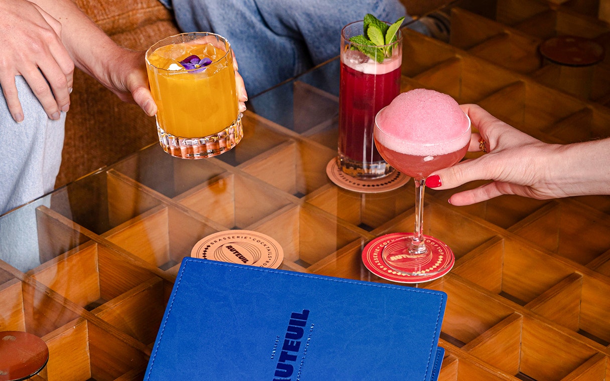 People enjoying cocktails at Brasserie Auteuil, Paris.