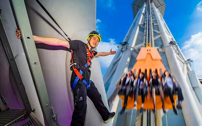 Visitors enjoying Sky Drop ride at Canton Tower, Guangzhou, with high-altitude walk attraction.