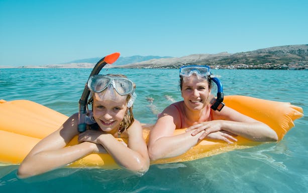 Snorkelers enjoying the clear waters near Podstrana, Split, Croatia.