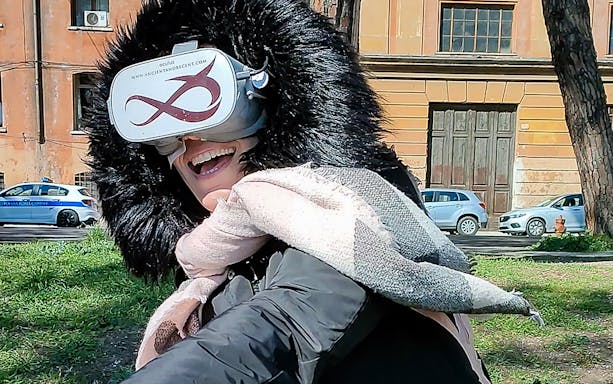 Person enjoying virtual reality game near Circus Maximus, Rome.
