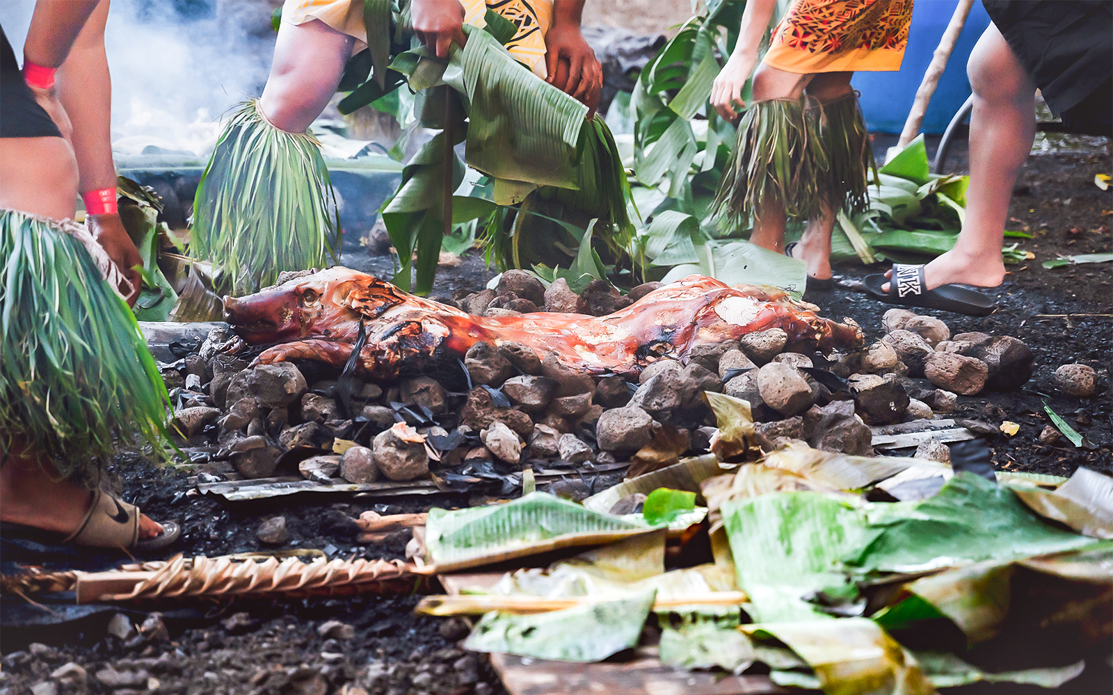 Kalua pig being prepared in a traditional Hawaiian Imu ceremony at Mauka Warriors Luau.