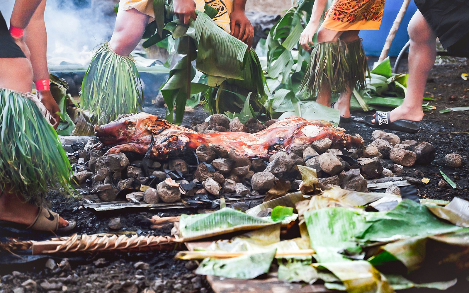 Kalua pig being prepared in a traditional Hawaiian Imu ceremony at Mauka Warriors Luau.