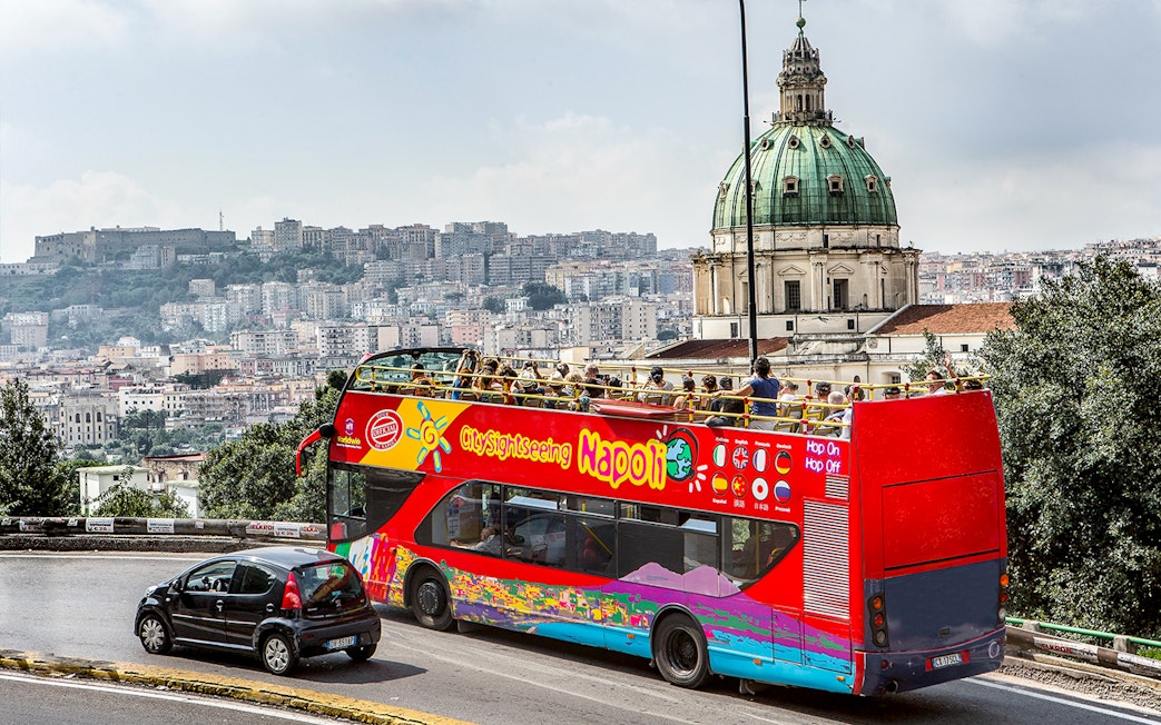 Open-top tour bus near Basilica of the Incarnate Mother of the Good Council, Naples.