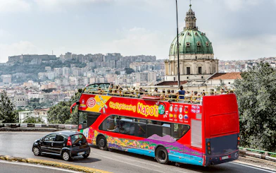 Open-top tour bus near Basilica of the Incarnate Mother of the Good Council, Naples.