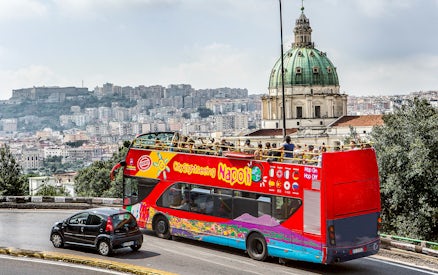 Open-top tour bus near Basilica of the Incarnate Mother of the Good Council, Naples.