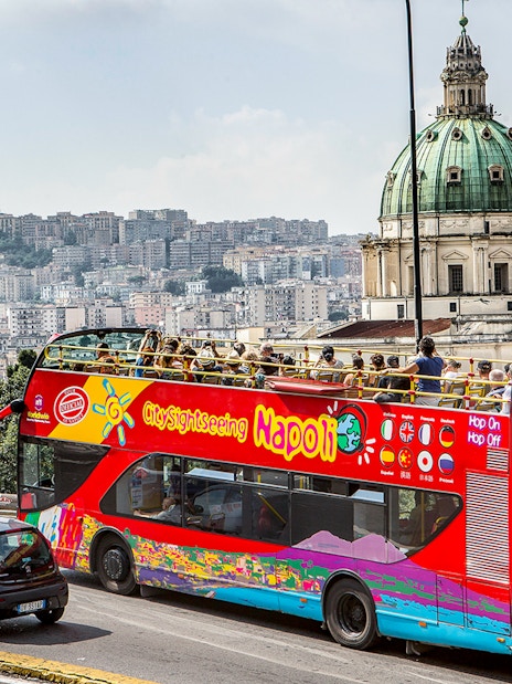 Open-top tour bus near Basilica of the Incarnate Mother of the Good Council, Naples.