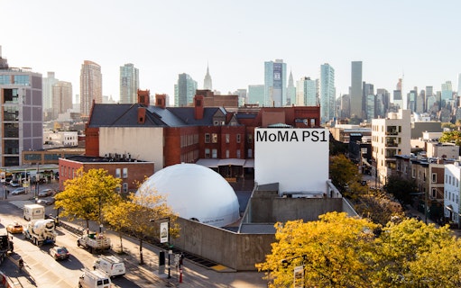 MoMA PS1 exterior with New York City skyline in the background.
