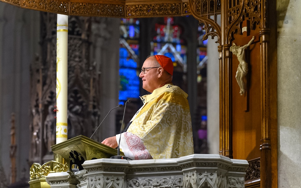 Clergy member speaking at St. Patrick's Cathedral event, New York City.