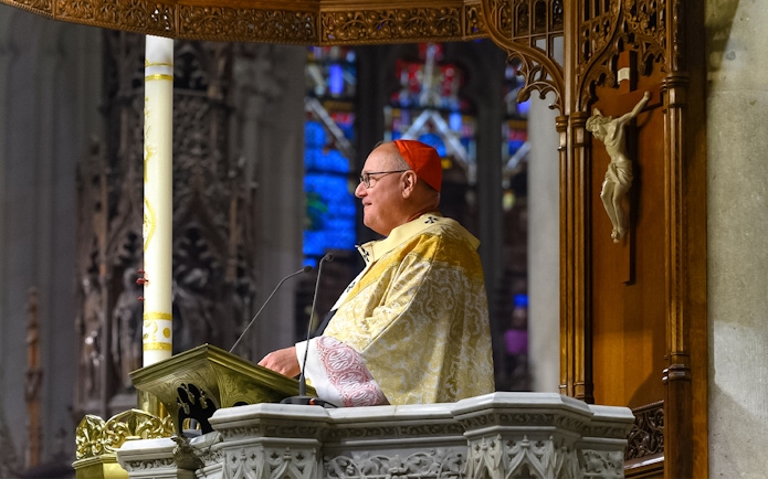 Clergy member speaking at St. Patrick's Cathedral event, New York City.