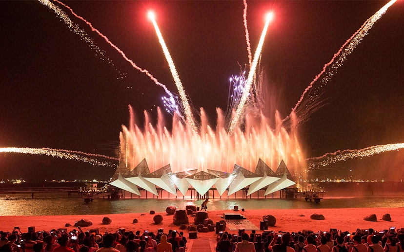 Tourists watching the Wings of Time light and sound show at Sentosa Island, Singapore.