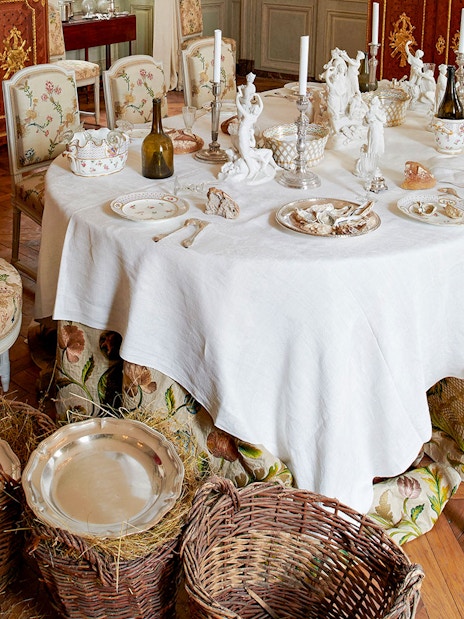Elegant dining room setup at Hôtel de la Marine with ornate tableware and chairs.