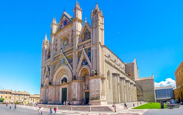 Cathedral of Orvieto facade with intricate carvings and colorful mosaics, Italy.