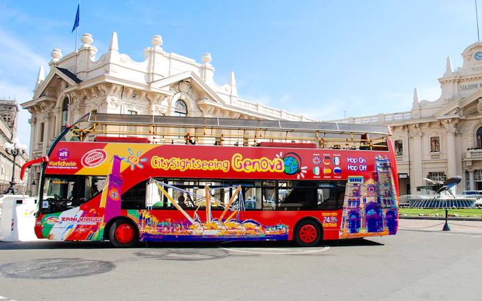 City Sightseeing Genova bus in front of historic building in Italy.