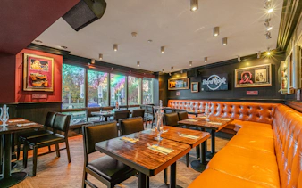 Dining area at Hard Rock Cafe, Amsterdam with set tables and music memorabilia.