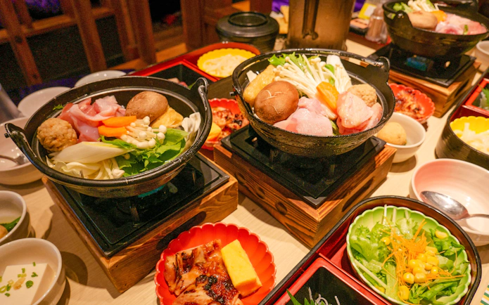 Traditional Japanese hot pot with vegetables and meat at Tokyo's Family Sumo Workshop.