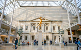 Golden statue of Diana in the Met Museum's American Wing, New York City.