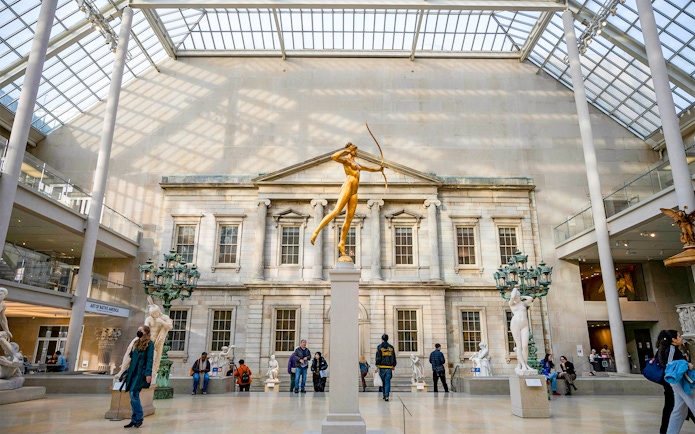 Golden statue of Diana in the Met Museum's American Wing, New York City.