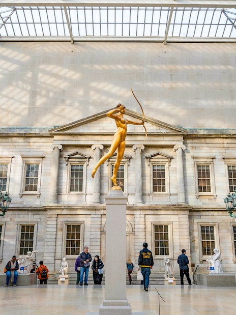 Golden statue of Diana in the Met Museum's American Wing, New York City.