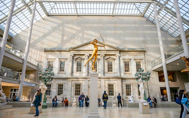 Golden statue of Diana in the Met Museum's American Wing, New York City.