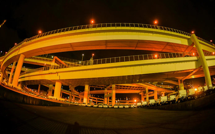 Elevated highway at night during Daikoku PA car meeting in Yokohama, Japan.