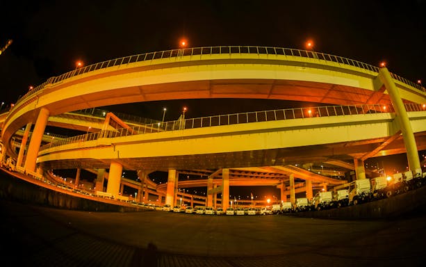 Elevated highway at night during Daikoku PA car meeting in Yokohama, Japan.