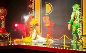 Performer in costume on stage at Piff the Magic Dragon show, Vegas.