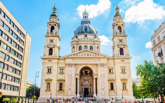 St. Stephen's Basilica exterior with tourists in Budapest, Hungary.