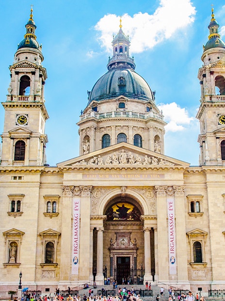 St. Stephen's Basilica exterior with tourists in Budapest, Hungary.