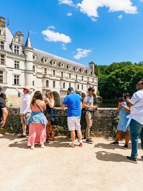 Group of tourists with a guide at Chambord Castle, France.
