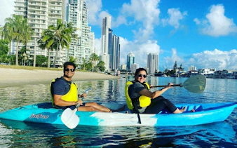 Kayakers on Surfers Paradise Guided Sunset Kayak Tour, Gold Coast with city skyline.