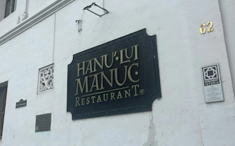 Hanu' lui Manuc restaurant sign on a historic building in Bucharest.