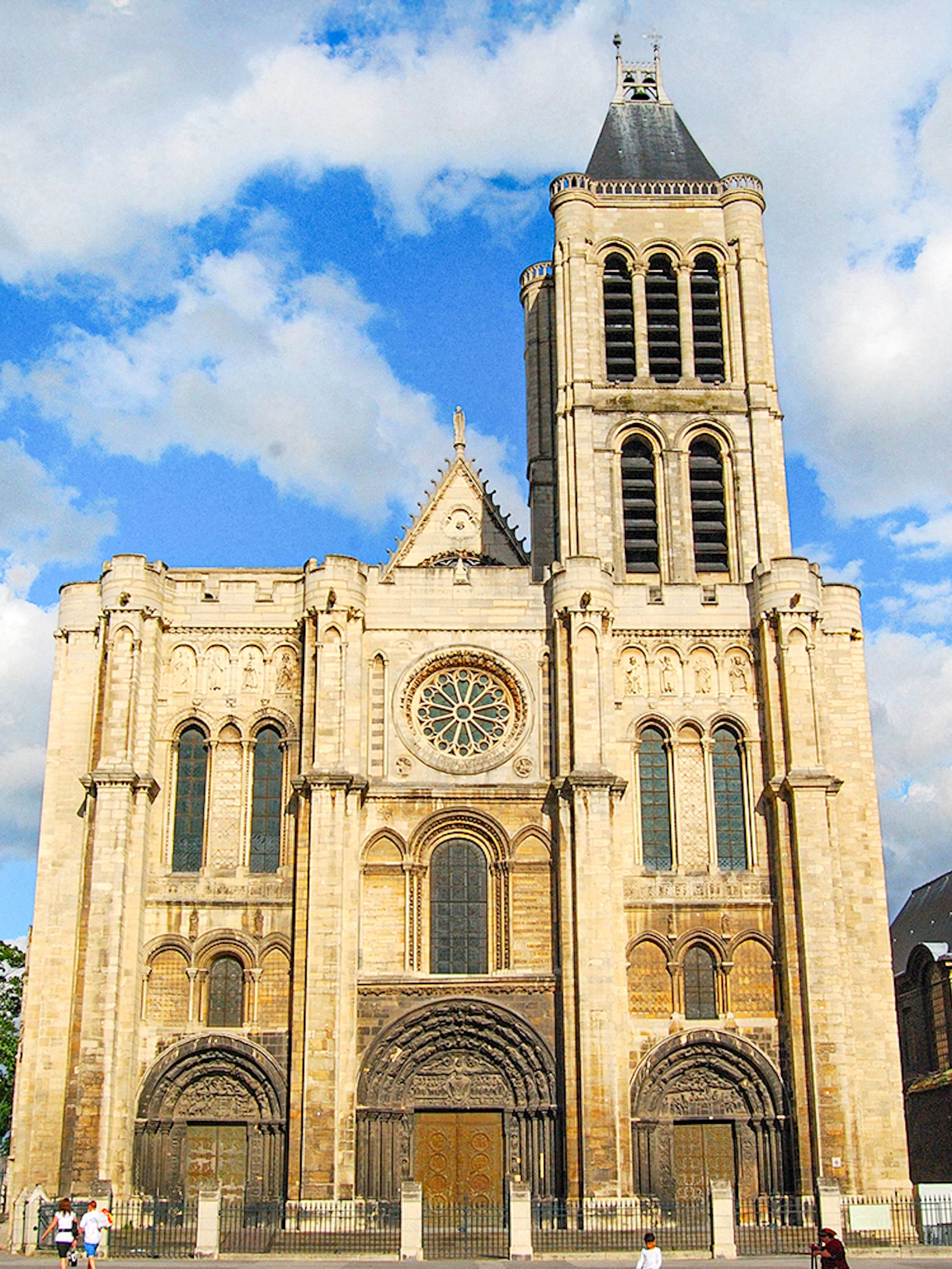 Basilica of Saint-Denis facade under blue sky, Paris, France.