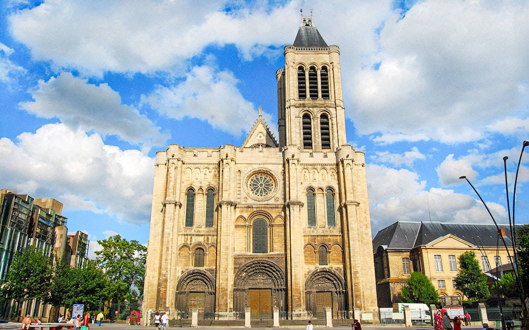 Basilica of Saint-Denis facade under blue sky, Paris, France.