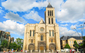 Basilica of Saint-Denis facade under blue sky, Paris, France.