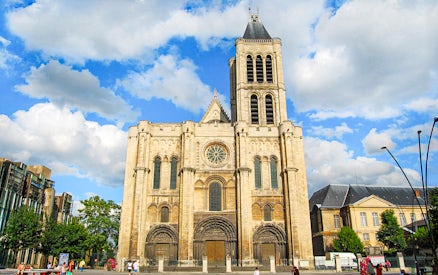 Basilica of Saint-Denis facade under blue sky, Paris, France.