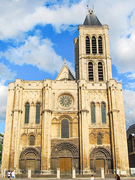Basilica of Saint-Denis facade under blue sky, Paris, France.