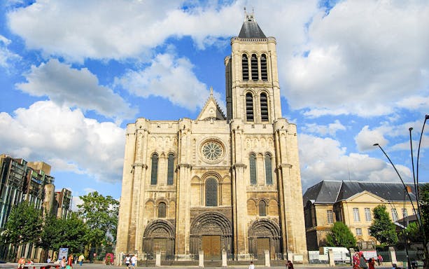 Basilica of Saint-Denis facade under blue sky, Paris, France.