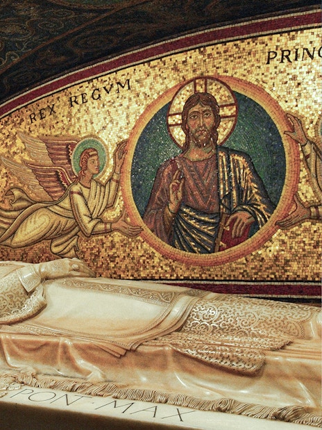Papal tomb with intricate mosaics in Vatican City's St. Peter's Basilica.