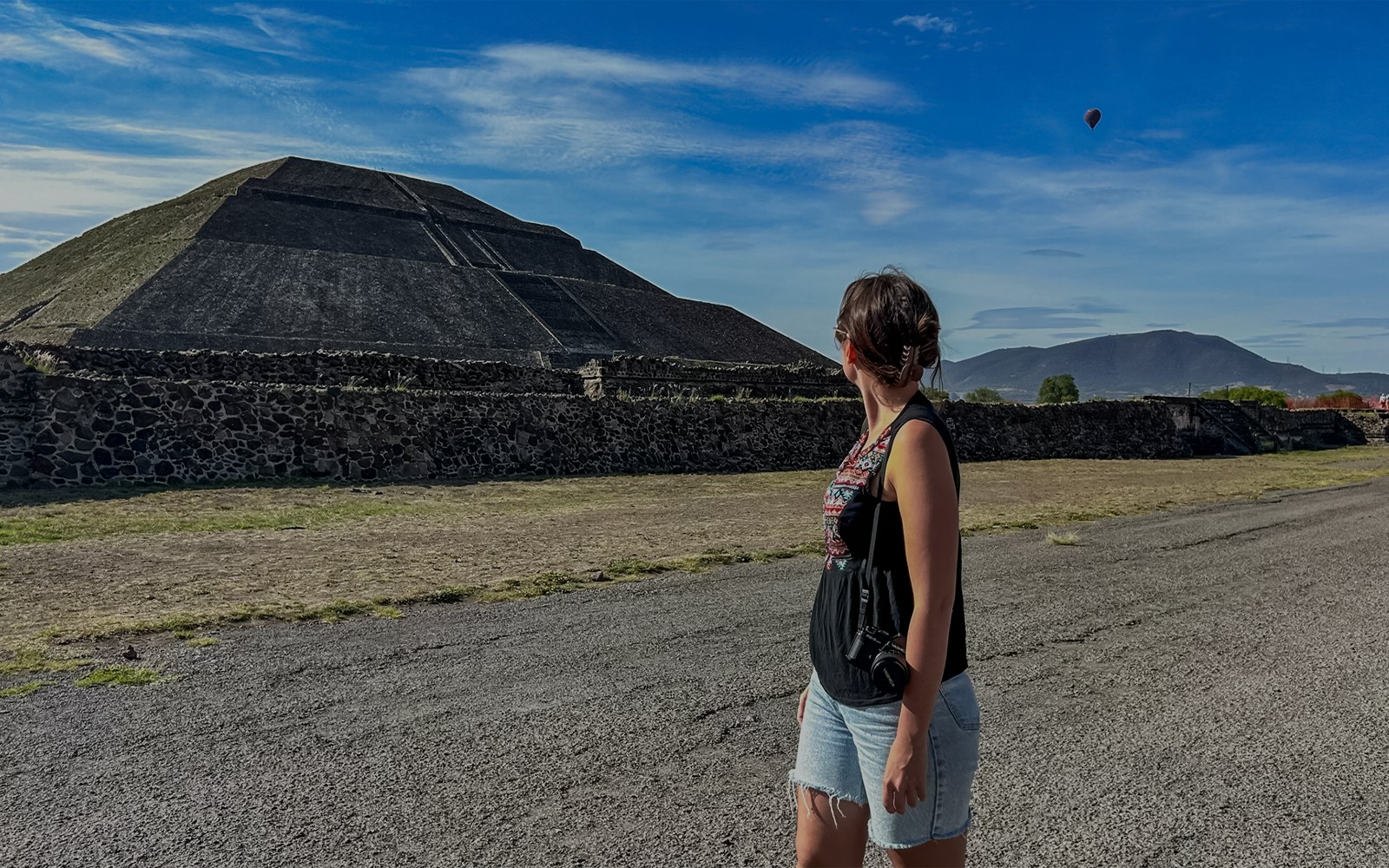 Teotihuacan Pyramid of the Sun with tourists exploring the ancient site in Mexico.