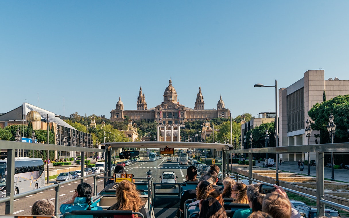 Tourists on Barcelona Bus Turistic viewing the National Art Museum of Catalonia.