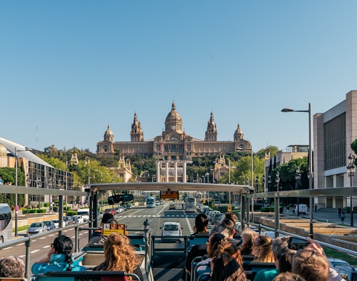 Tourists enjoying the Barcelona Bus Turistic Hop-On-Hop-Off Tour with a view of the city's iconic landmarks