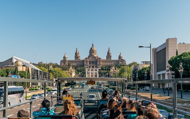 Tourists on Barcelona Bus Turistic viewing the National Art Museum of Catalonia.