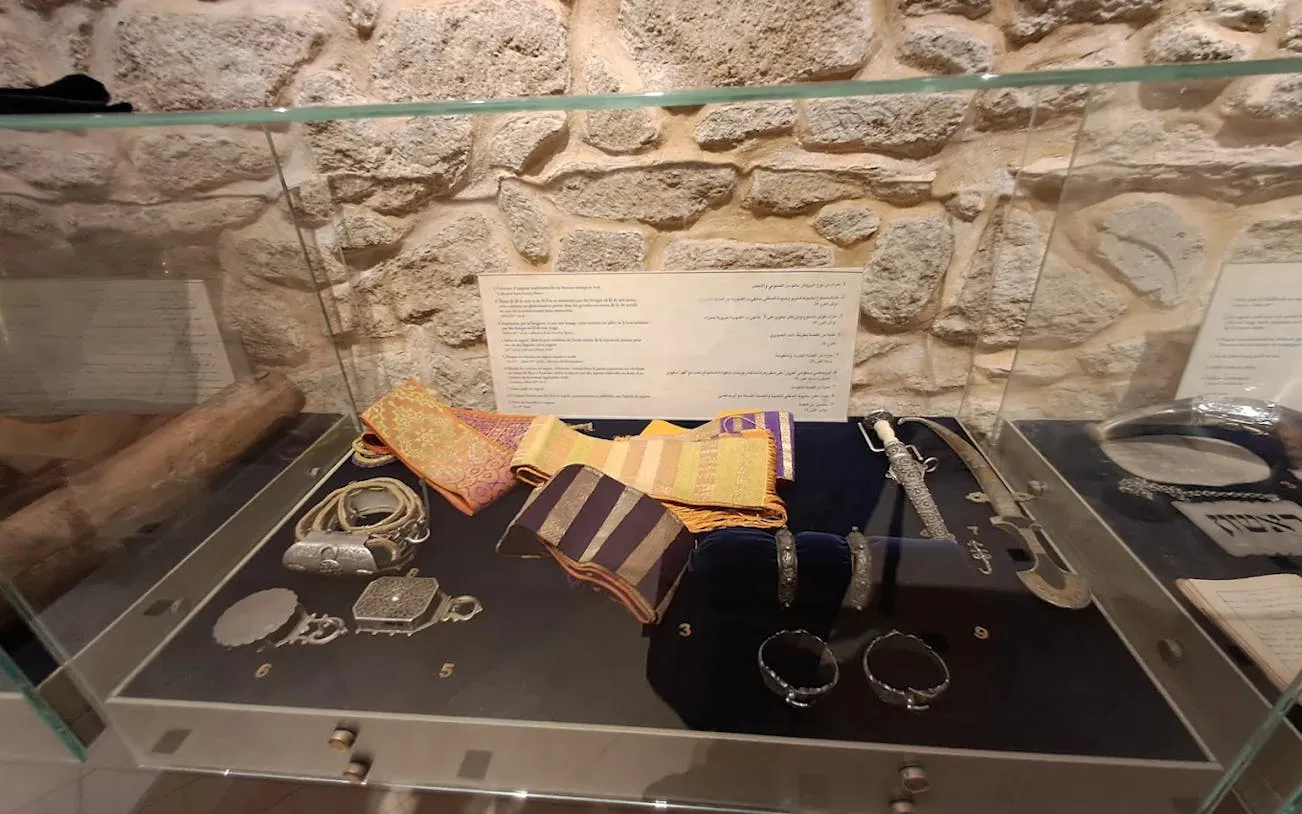 Artifacts displayed in Bayt Dakira, Essaouira, including traditional jewelry and textiles.